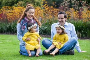 famiglia di quattro avendo divertimento all'aperto nel un' bellissimo soleggiato giorno a il parco. felicità concetto. famiglia concetto. foto