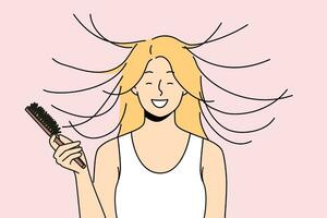 donna pettini capelli e sorrisi, vedendo effetto di statico magnetizzazione di acconciatura. foto