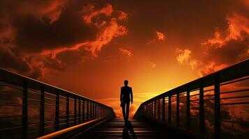 uomo d'affari a piedi su ponte a tramonto. silhouette concetto foto