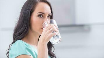 giovane donna bevande pulito acqua aderisce per potabile regime. foto