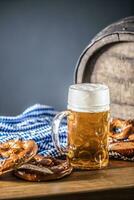 oktoberfest grande birra con salatino di legno barile e blu tovaglia foto