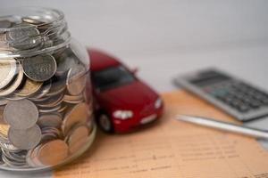 auto con monete in barattolo di vetro prestito auto, finanza, risparmio di denaro, banche, assicurazioni e concetti di tempo di leasing.