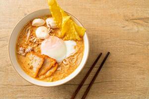vermicelli di riso con polpette, maiale arrosto e uova in zuppa piccante foto