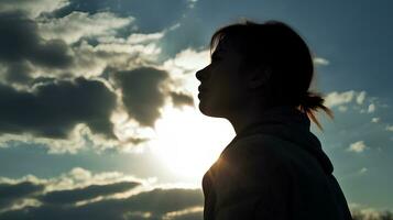 silhouette di un' stanco e stressato donna contro il cielo, sole foto