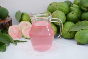 fresco guaiava succo nel un' bicchiere e fresco guaiava frutta. foto