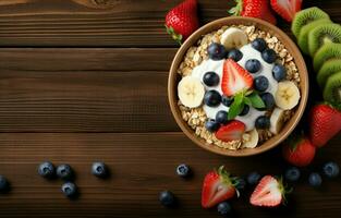 ciotola di fatti in casa muesli sormontato con Miele, Yogurt, e fresco frutti di bosco Compreso fragole, mirtilli, Kiwi, e banane su un' di legno tavolo. tiro a partire dal sopra, piatto posare Visualizza. foto