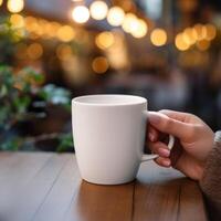 ai generativo donne mano Tenere un' bianca caffè tazza, vicino - su, con sfocatura sfondo di bar foto