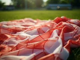 rosso e bianca plaid picnic coperta su superiore di un' verde campo nel soleggiato giorno su erba di prato nel estate parco. sfocato sfondo. generativo ai foto