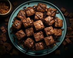 cioccolato brownies su un' blu piatto su un' nero sfondo generativo ai foto