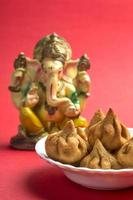 modak di cibo indiano con idolo di Lord Ganesha, piatto dolce del maharashtra, design di biglietti di auguri. foto
