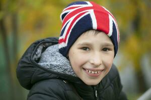 contento bambino nel un' cappello con il Britannico bandiera. foto