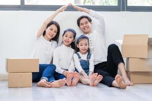 le giovani famiglie asiatiche si trasferiscono insieme in una nuova casa foto