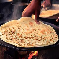 indiano roti o pane essere al forno su un' padella. ai generativo foto