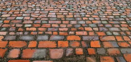 ciottolo marciapiede vicino su di il dettaglio ciottoli nel un vecchio strada strada superficie fatto di Marrone rettangolare pietre.vecchio strada granito pietre 3d illustrazione foto