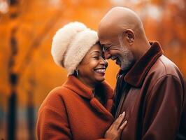 amorevole vecchio africano americano coppia è godendo un' romantico autunno giorno ai generativo foto