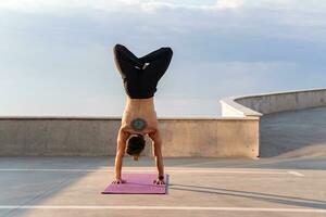 attraente bello uomo con atletico forte corpo fare mattina yoga asana all'aperto foto