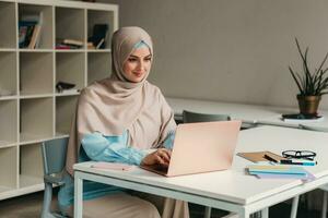 moderno musulmano donna nel hijab nel ufficio camera foto