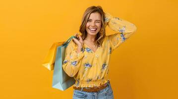 bellissimo attraente sorridente donna nel giallo camicia e jeans Tenere shopping borse foto