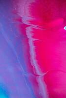 astratto creato utilizzando il tecnica di liquido acrilico. macro fotografia di il il più piccolo dettagli di un' ansimante. il ansimante Spettacoli Come trabocca di occhiali da sole e colori di dipingere somigliare spazio motivi. foto