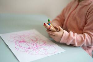 un' piccolo bambino è apprendimento per disegnare un' immagine foto