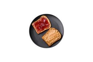 nutriente panini consistente di pane, lampone marmellata e arachide burro foto