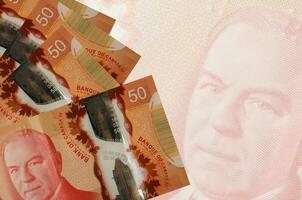 50 canadese dollari fatture bugie nel pila su sfondo di grande semi trasparente banconota. astratto attività commerciale sfondo foto