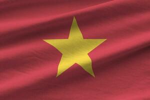 Vietnam bandiera con grande pieghe agitando vicino su sotto il studio leggero al chiuso. il ufficiale simboli e colori nel bandiera foto