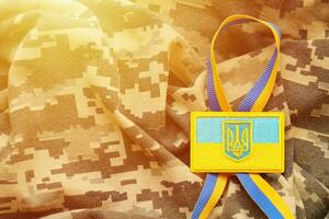 militare camuffare tessuto con ucraino bandiera su uniforme gallone foto