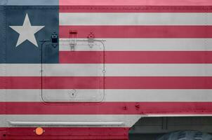 Liberia bandiera raffigurato su lato parte di militare blindato camion avvicinamento. esercito forze concettuale sfondo foto