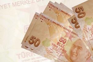 50 Turco lire fatture bugie nel pila su sfondo di grande semi trasparente banconota. astratto presentazione di nazionale moneta foto