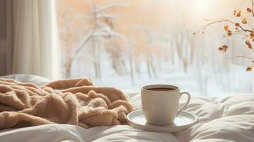 accogliente foto. un' tazza di caffè, un' coperta di il finestra, inverno foto