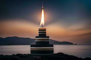 un' torta con un' illuminato candela su superiore di un' roccia. ai-generato foto
