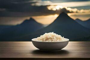 un' ciotola di riso su un' tavolo nel davanti di montagne. ai-generato foto