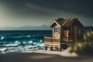 un' miniatura di legno Casa su il spiaggia. ai-generato foto