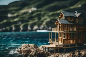 un' miniatura Casa su un' roccia di il oceano. ai-generato foto