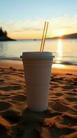 costiero caffè beatitudine bianca tazza, nero cannuccia su sabbioso spiaggia a Alba o tramonto verticale mobile sfondo ai generato foto