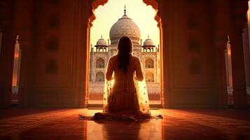 un' donna nel sari preghiera a taj mahal, India. generativo ai. foto