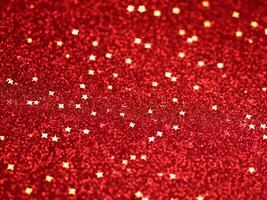 rosso Natale luccichio sfondo con stelle. festivo raggiante sfocato struttura. foto