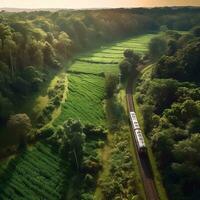 un aereo Visualizza di un' treno passaggio attraverso un' lussureggiante campagna generativo ai foto