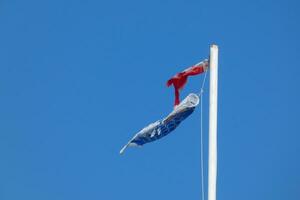 colorato bandiere sotto il blu cielo svolazzanti nel il vento foto
