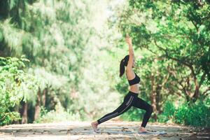 giovane donna asiatica che fa yoga al mattino al parco. sano foto