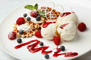 gelato alla vaniglia e waffle con frutti di bosco freschi foto