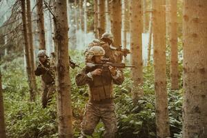 un' gruppo di moderno guerra soldati è combattente un' guerra nel pericoloso a distanza foresta le zone. un' gruppo di soldati è combattente su il nemico linea con moderno Armi. il concetto di guerra e militare conflitti foto