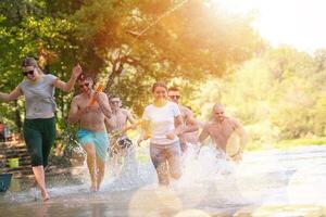 estate gioia amici avendo divertimento su fiume foto