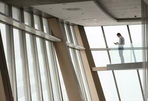 giovane riuscito attività commerciale uomo nel attico appartamento Lavorando su tavola foto