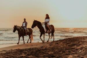 un' amorevole coppia nel estate Abiti equitazione un' cavallo su un' sabbioso spiaggia a tramonto. mare e tramonto nel il sfondo. selettivo messa a fuoco foto