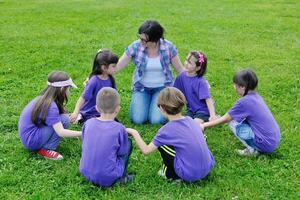 gruppo di bambini felici con insegnante in natura foto