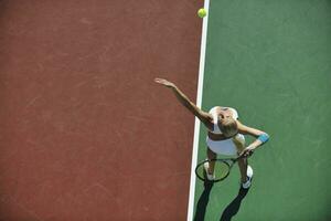 giovane donna giocare a tennis all'aperto foto