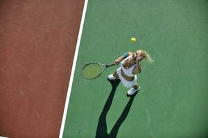 giovane donna giocare a tennis all'aperto foto