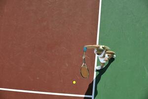 giovane donna giocare a tennis all'aperto foto